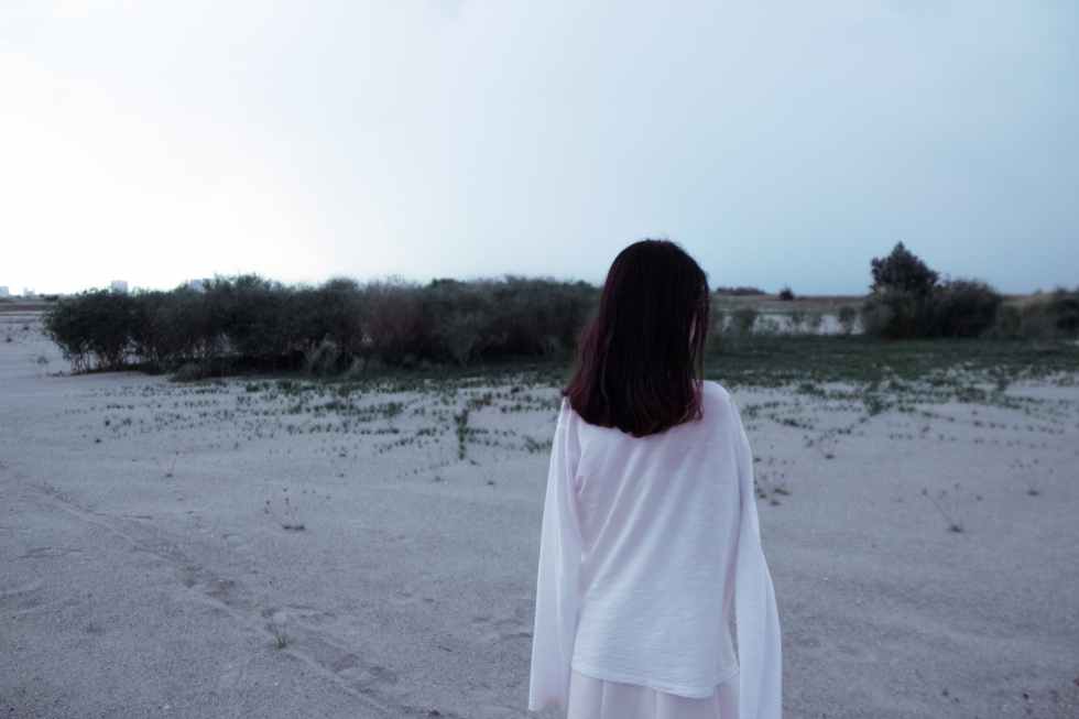 rear view of woman standing on beach