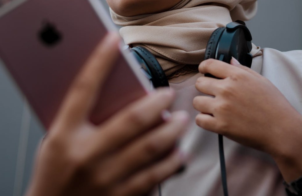 a woman holding his cellular phone